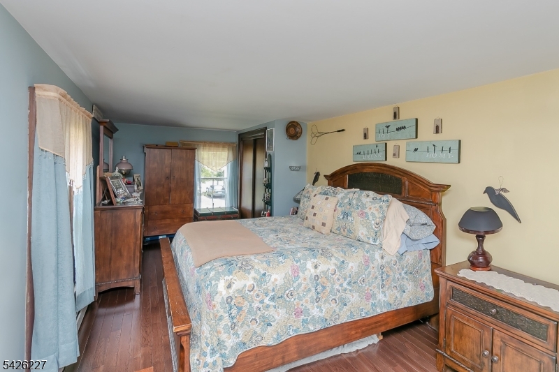 36 Main Street Flanders, NJ 07836 - Photo 21 of 49 a bedroom with a bed and wooden floor