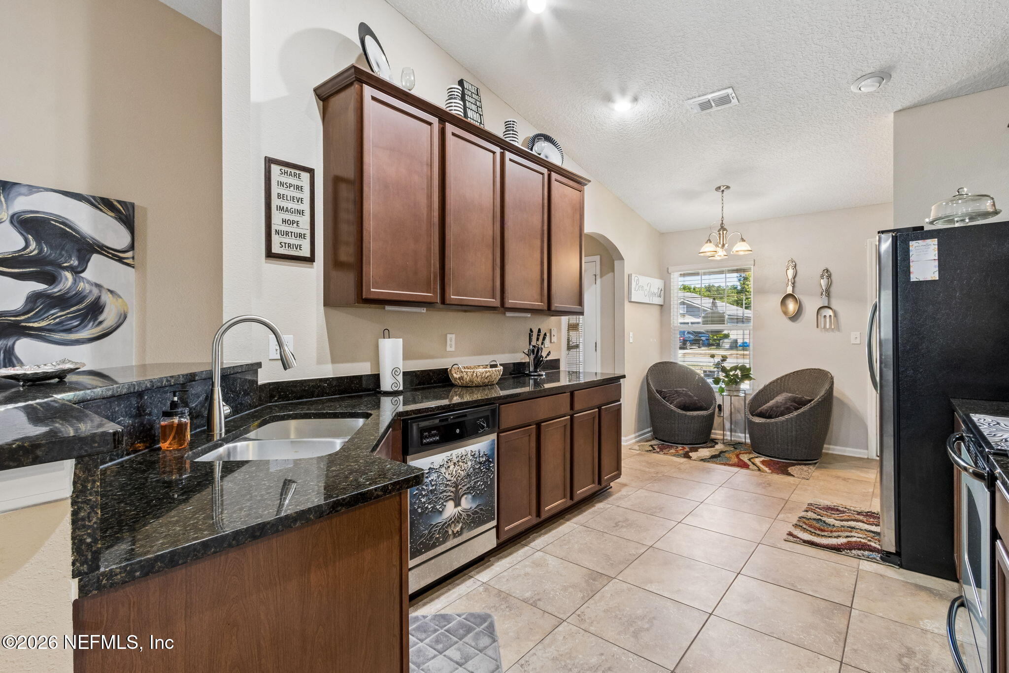 96034 Bass Lane Yulee, FL 32097 - Photo 18 of 50 a kitchen with granite countertop a sink appliances and cabinets