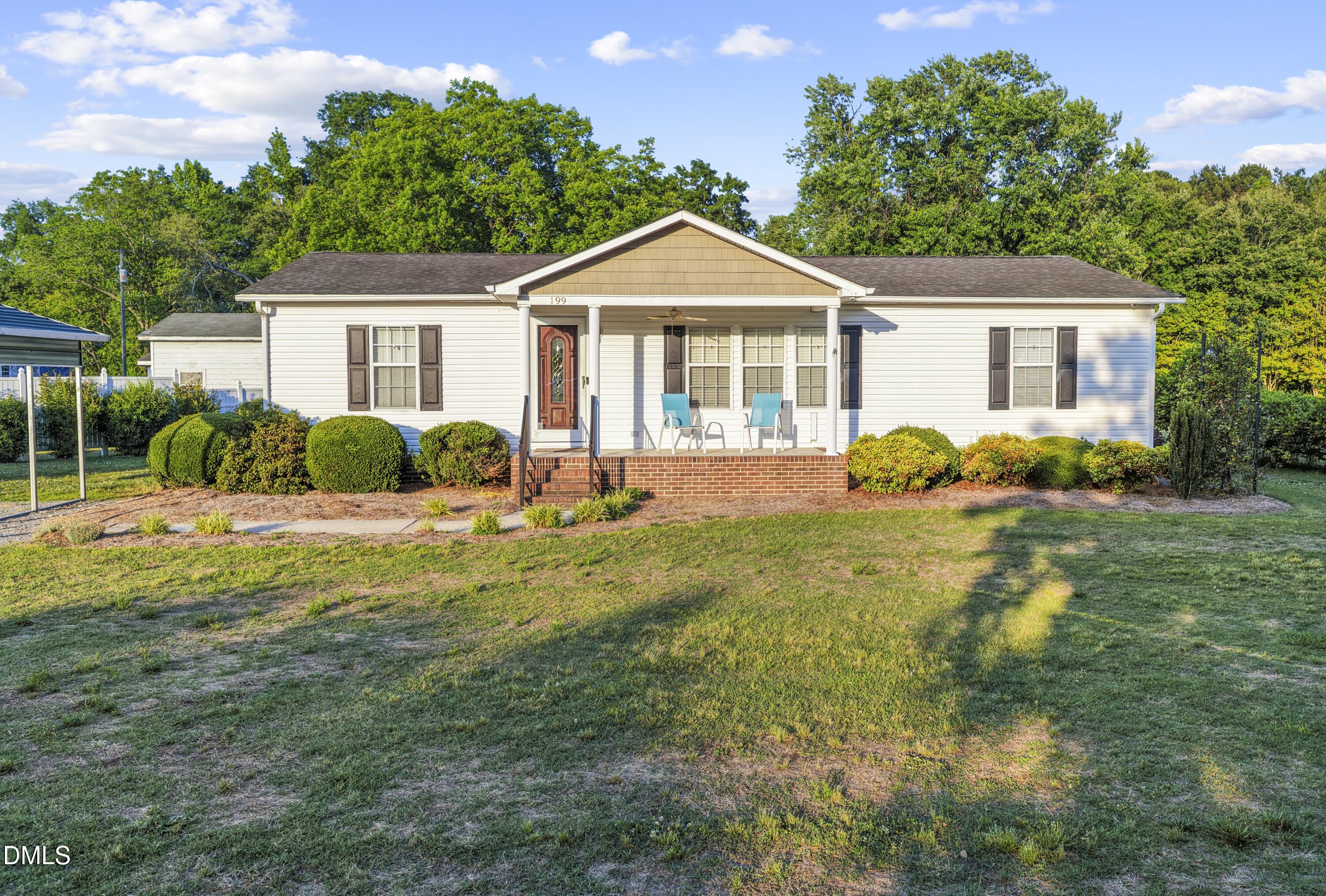 199 Iris Bryant Road Erwin, NC 28339 - Photo 2 of 33 a front view of a house with garden