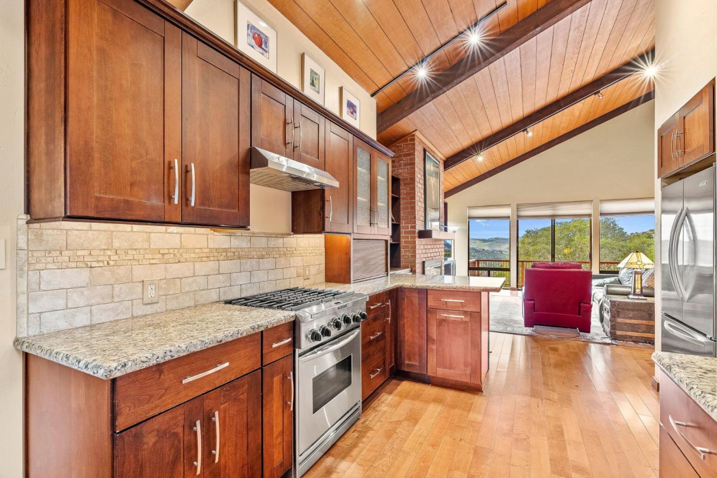 15460 Weather Rock Way Salinas, CA 93908 - Photo 9 of 32 a kitchen with stainless steel appliances granite countertop a stove a sink dishwasher and cabinets with wooden floor