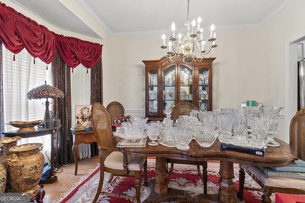 643 Millrun Court Macon, GA 31210 - Photo 20 of 45 a view of a dining room with furniture and chandelier