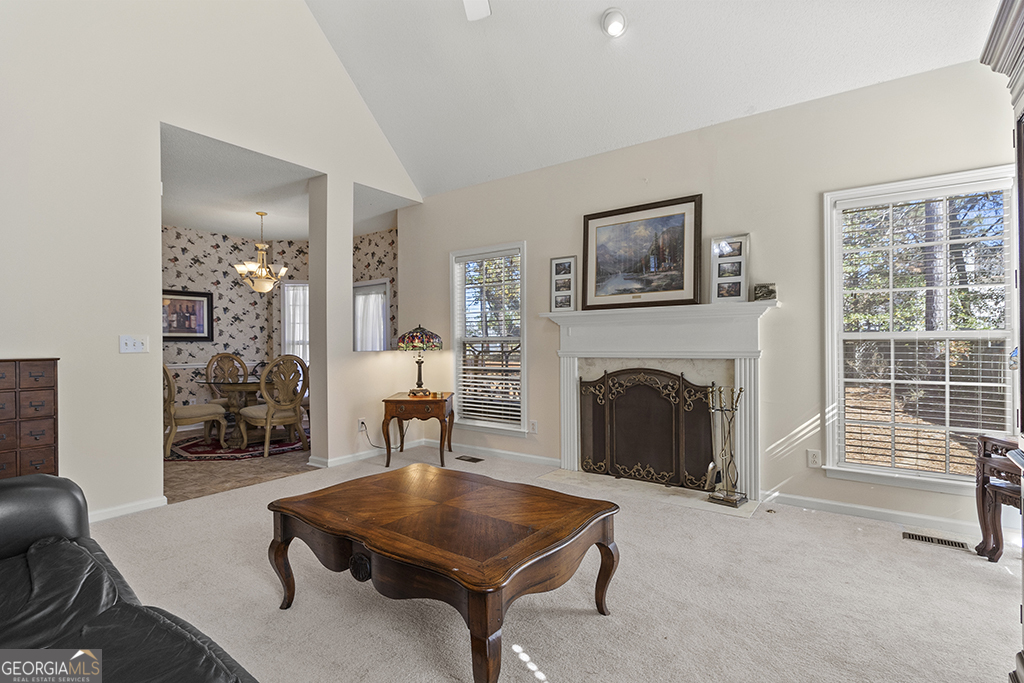 643 Millrun Court Macon, GA 31210 - Photo 32 of 45 a living room with furniture a fireplace and a table