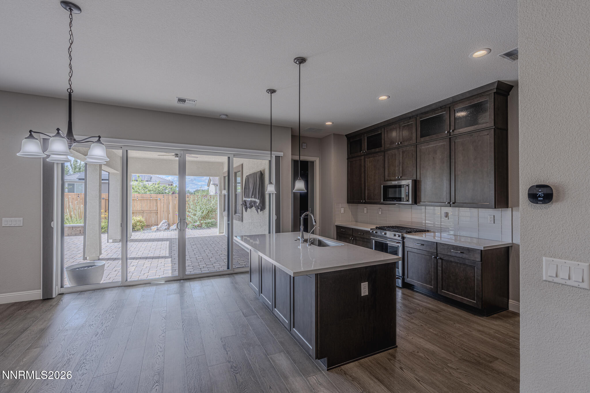 2109 Cast Iron Drive Reno, NV 89521 - Photo 8 of 35 a large kitchen with stainless steel appliances a stove a sink dishwasher a refrigerator and a wooden floor