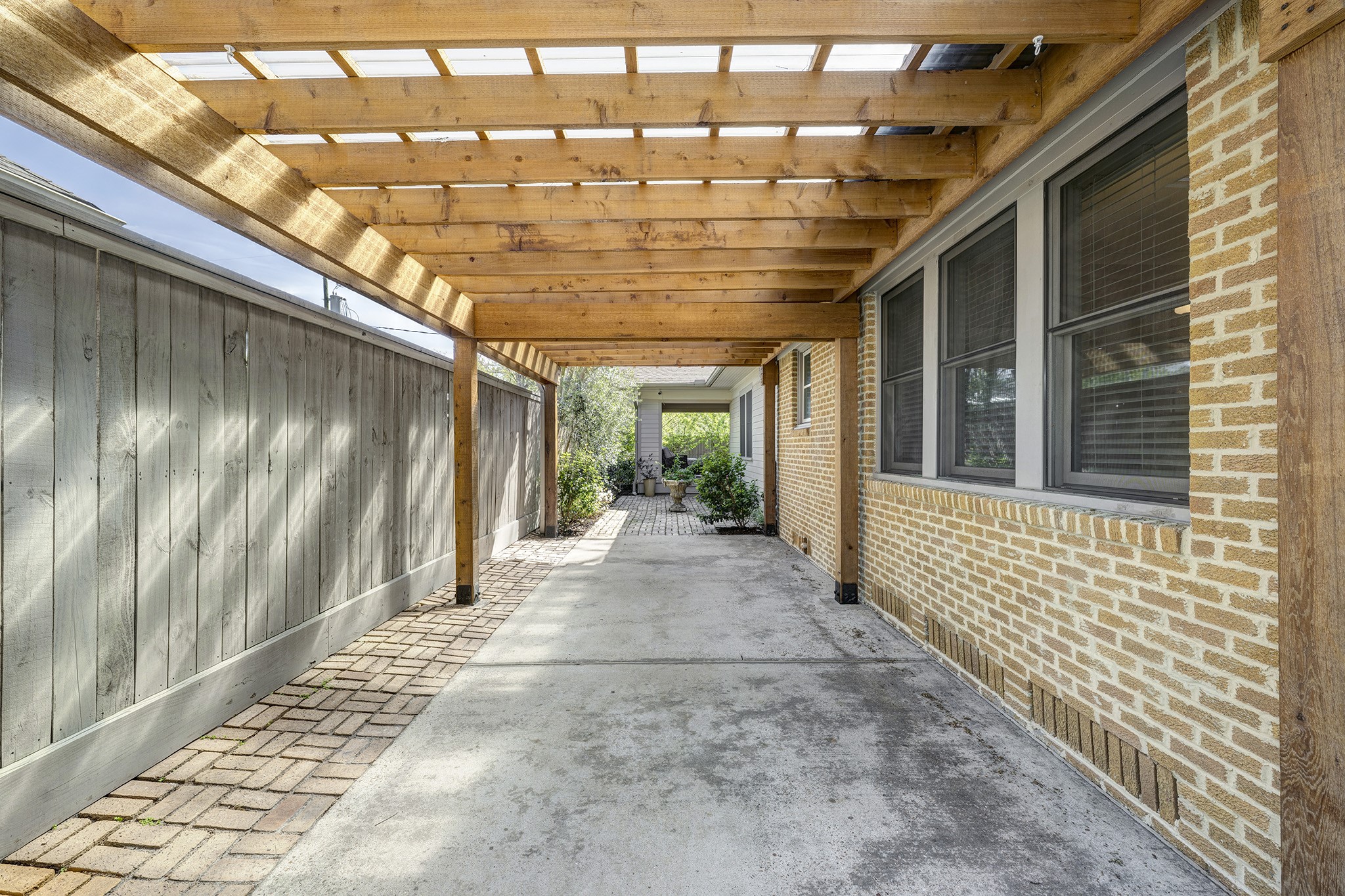 1314 Harvard Street Houston, TX 77008 - Photo 35 of 36 a view of a porch with a table and chairs and floor to ceiling window