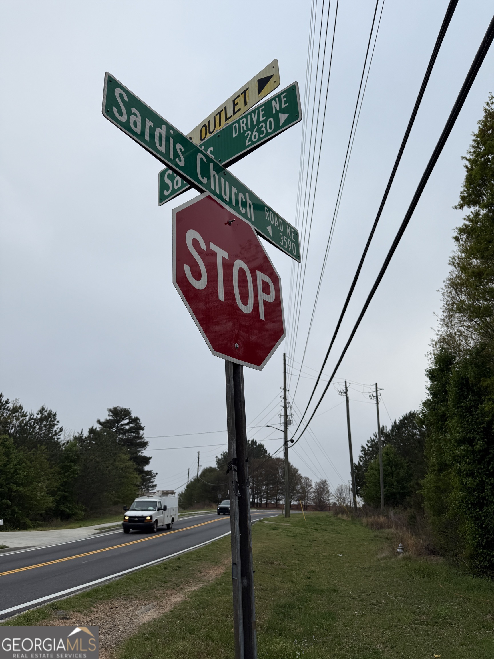 3550-3570 Sardis Church Road Buford, GA 30519 - Photo 4 of 6 a view of a street with sign on the wall