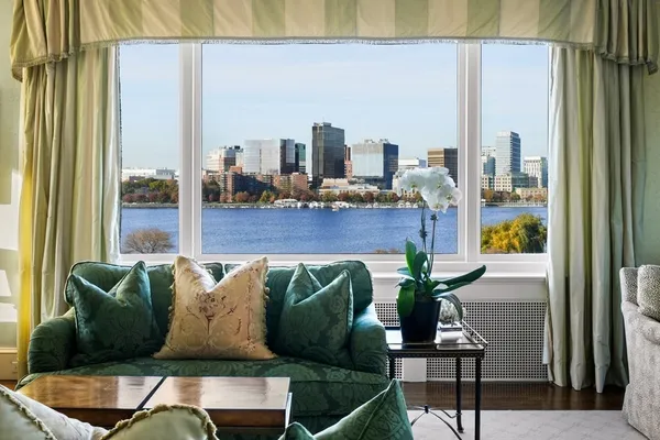 a living room with furniture and a floor to ceiling window