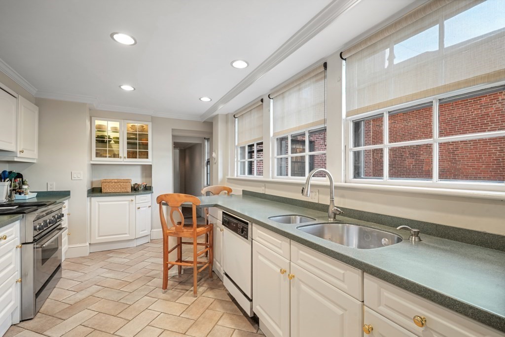 282 Beacon Street, Unit 6 Boston, MA 02116 - Photo 15 of 26 a kitchen with a sink and chairs