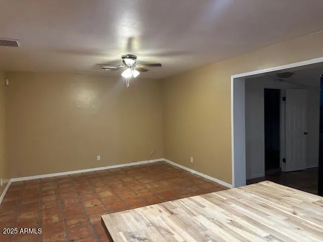 a bedroom with a bed and a chandelier fan