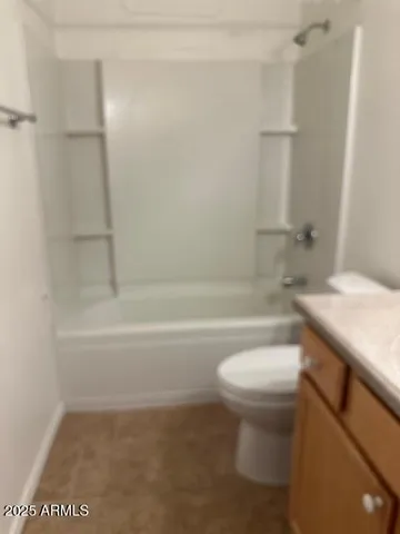 a bathroom with a granite countertop toilet a sink and a bathtub