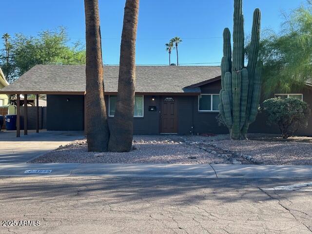 1025 West 12th Place Tempe, AZ 85281 - Photo 2 of 25 a front view of a house with a garden