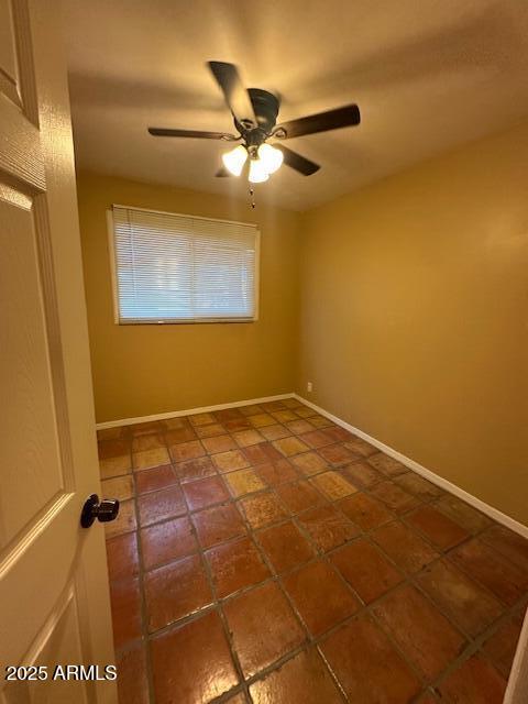 1025 West 12th Place Tempe, AZ 85281 - Photo 21 of 25 an empty room with a ceiling fan and a window