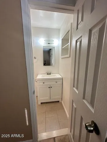 a view of bathroom with a sink a mirror and a shower