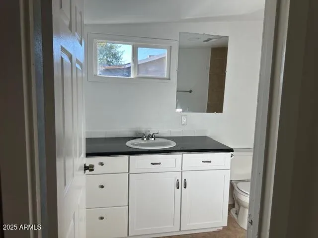 a sink with white cabinets
