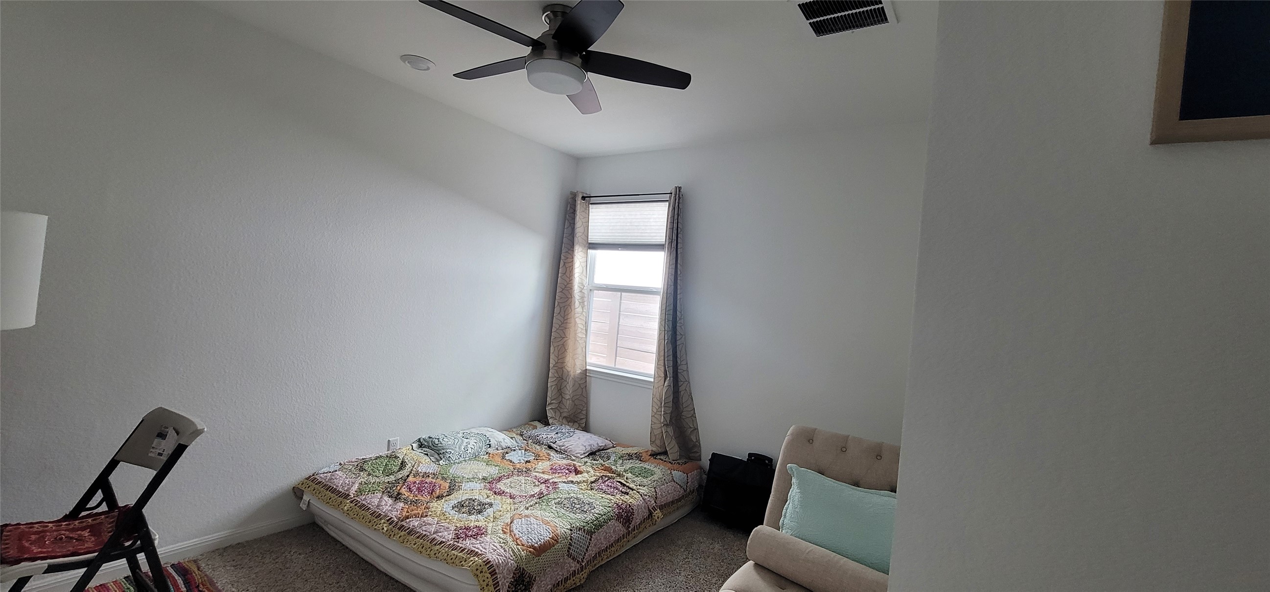716 Leeward Pass Leander, TX 78641 - Photo 15 of 26 A well-lit bedroom features a ceiling fan for optimal comfort and air circulation.
