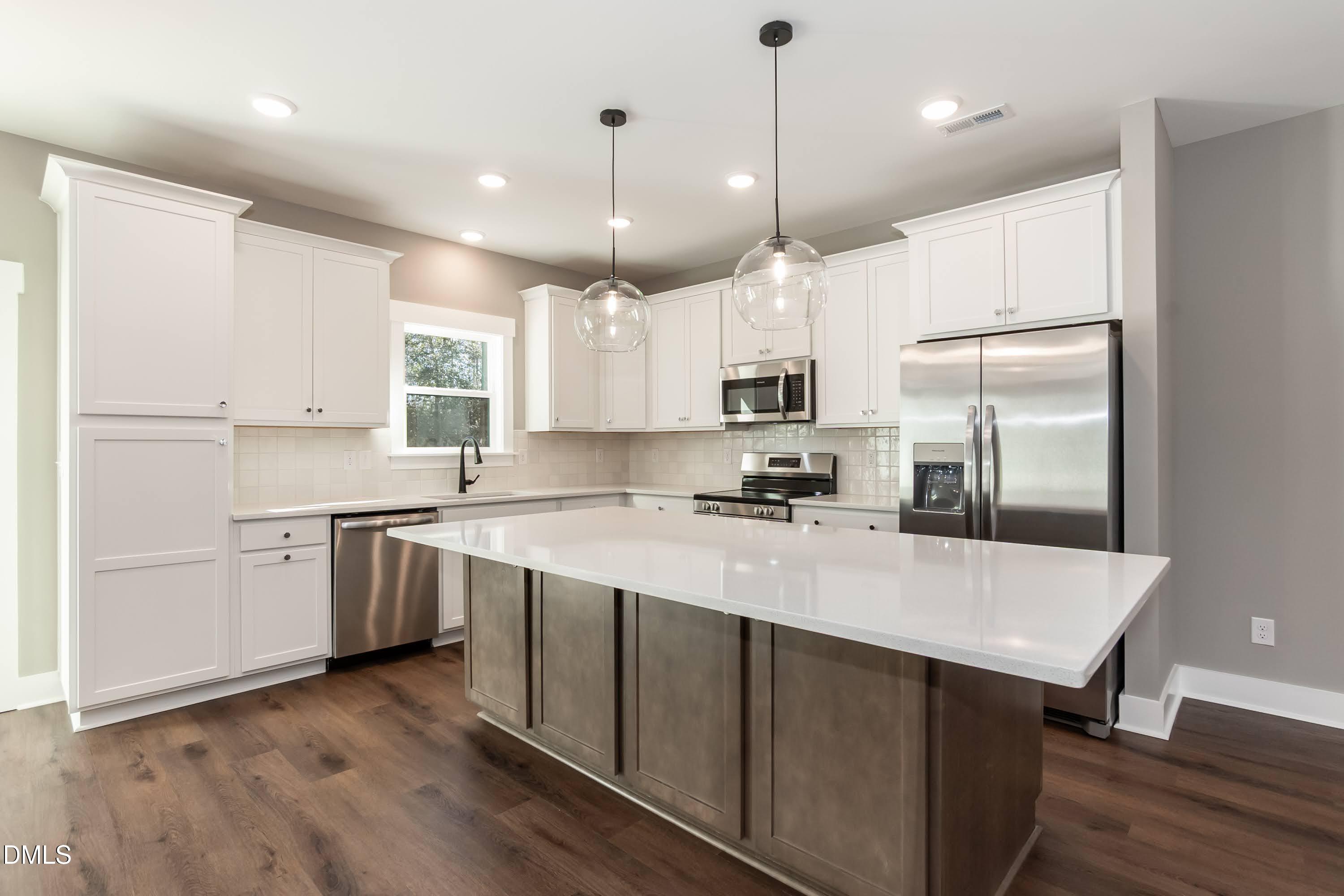 104 Buffalo Drive Spring Hope, NC 27882 - Photo 13 of 48 a large kitchen with a center island stainless steel appliances and cabinets