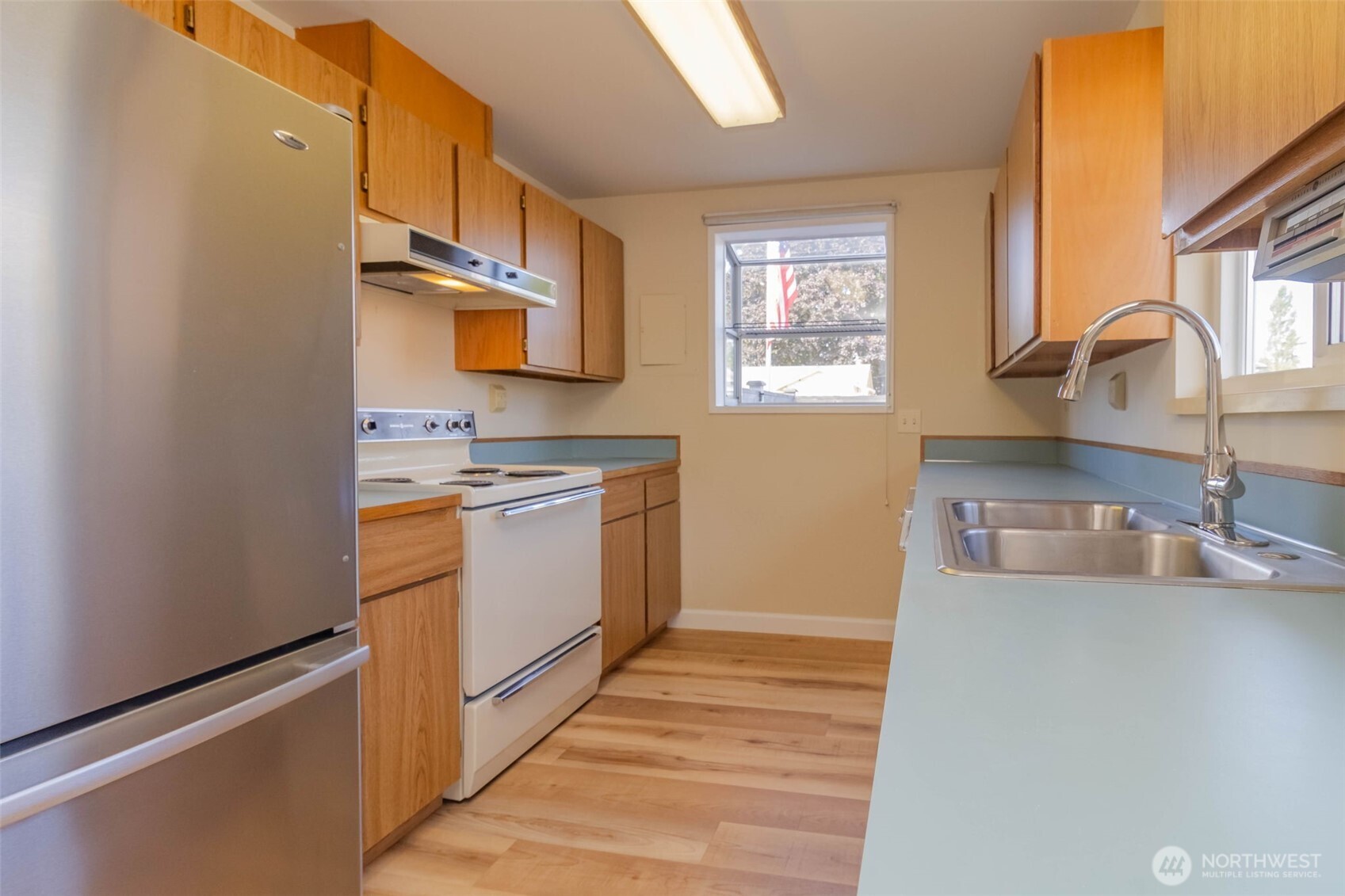 16958 121st Avenue Southeast Renton, WA 98058 - Photo 13 of 34 a kitchen with a sink cabinets and window