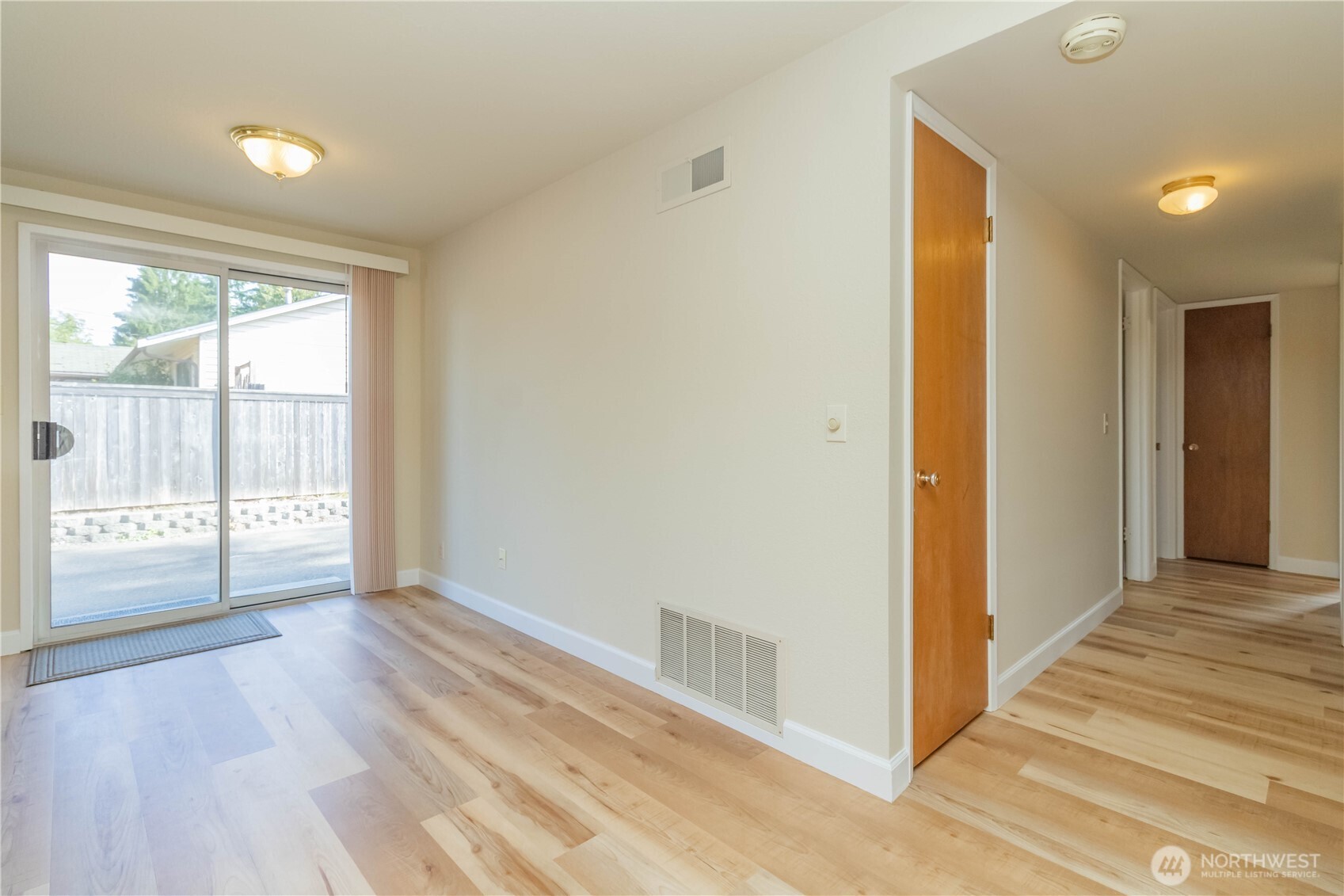 16958 121st Avenue Southeast Renton, WA 98058 - Photo 15 of 34 a view of an empty room with wooden floor and a window