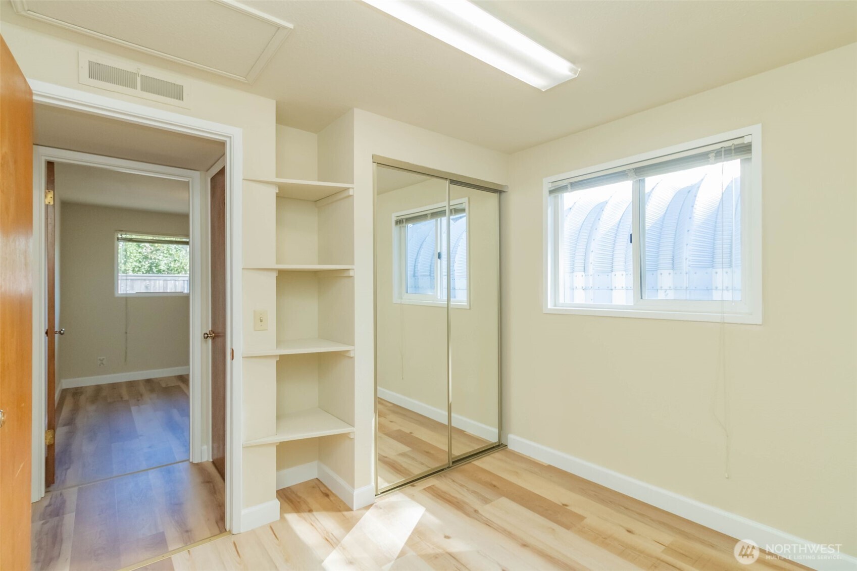 16958 121st Avenue Southeast Renton, WA 98058 - Photo 20 of 34 a view of an empty room with wooden floor and a window