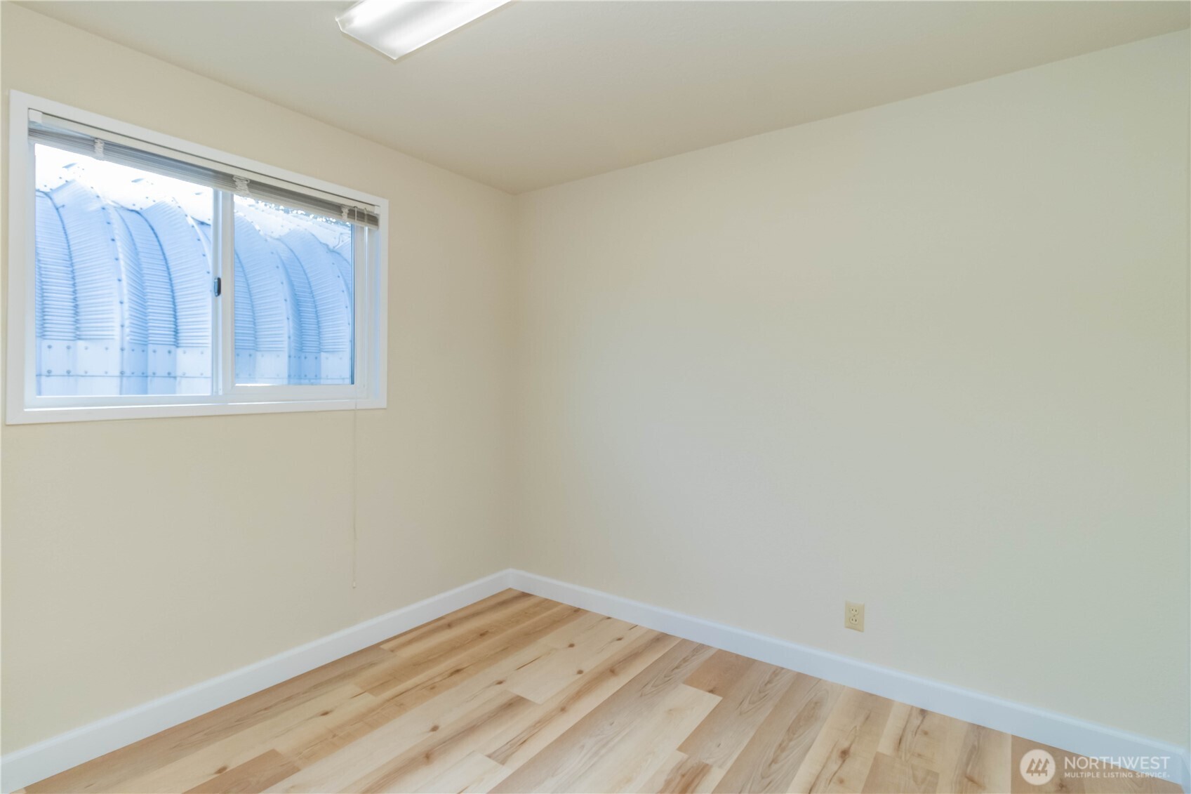 16958 121st Avenue Southeast Renton, WA 98058 - Photo 22 of 34 a view of an empty room with wooden floor and a window