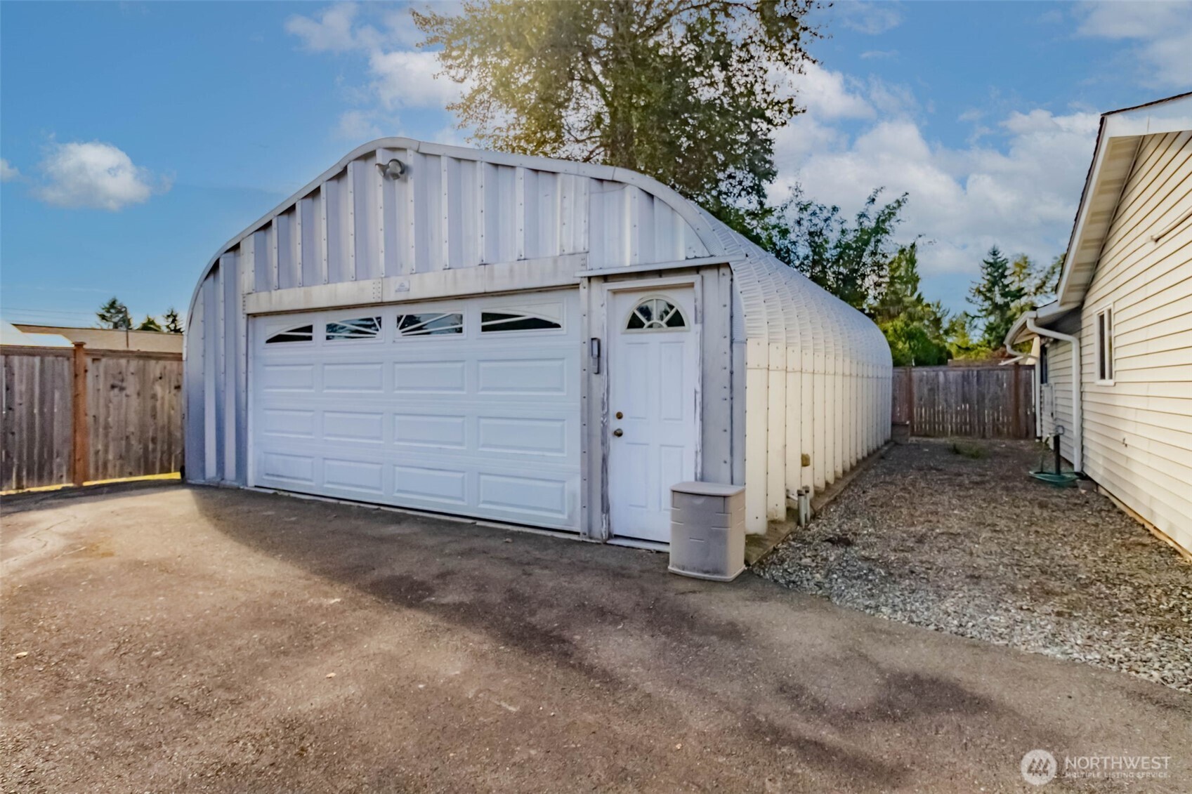 16958 121st Avenue Southeast Renton, WA 98058 - Photo 31 of 34 a view of a small house with wooden fence