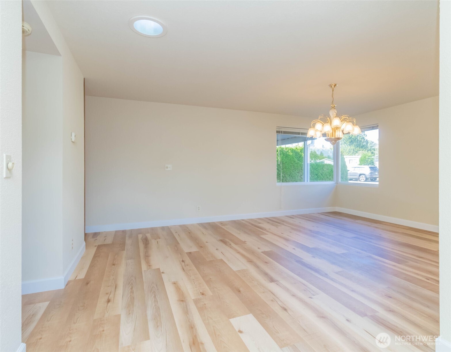 16958 121st Avenue Southeast Renton, WA 98058 - Photo 8 of 34 a view of empty room with window and wooden floor