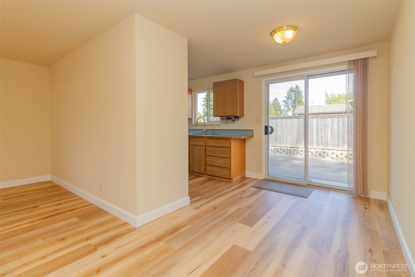 16958 121st Avenue Southeast Renton, WA 98058 - Photo 10 of 34 an empty room with wooden floor cabinet and windows