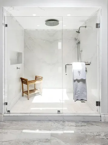 a spacious bedroom with a bed and wooden floor