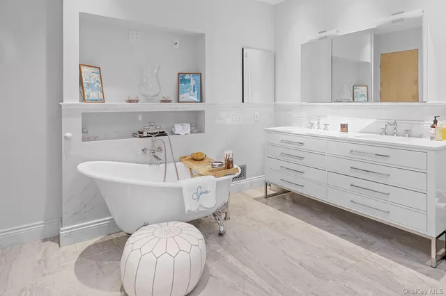 a spacious bedroom with a bed and wooden floor