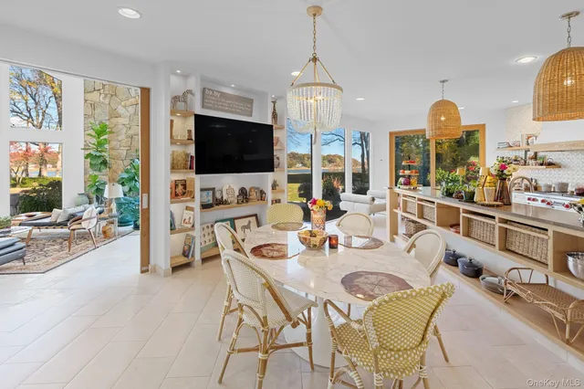 a kitchen with stainless steel appliances granite countertop a stove top oven and a view of living room