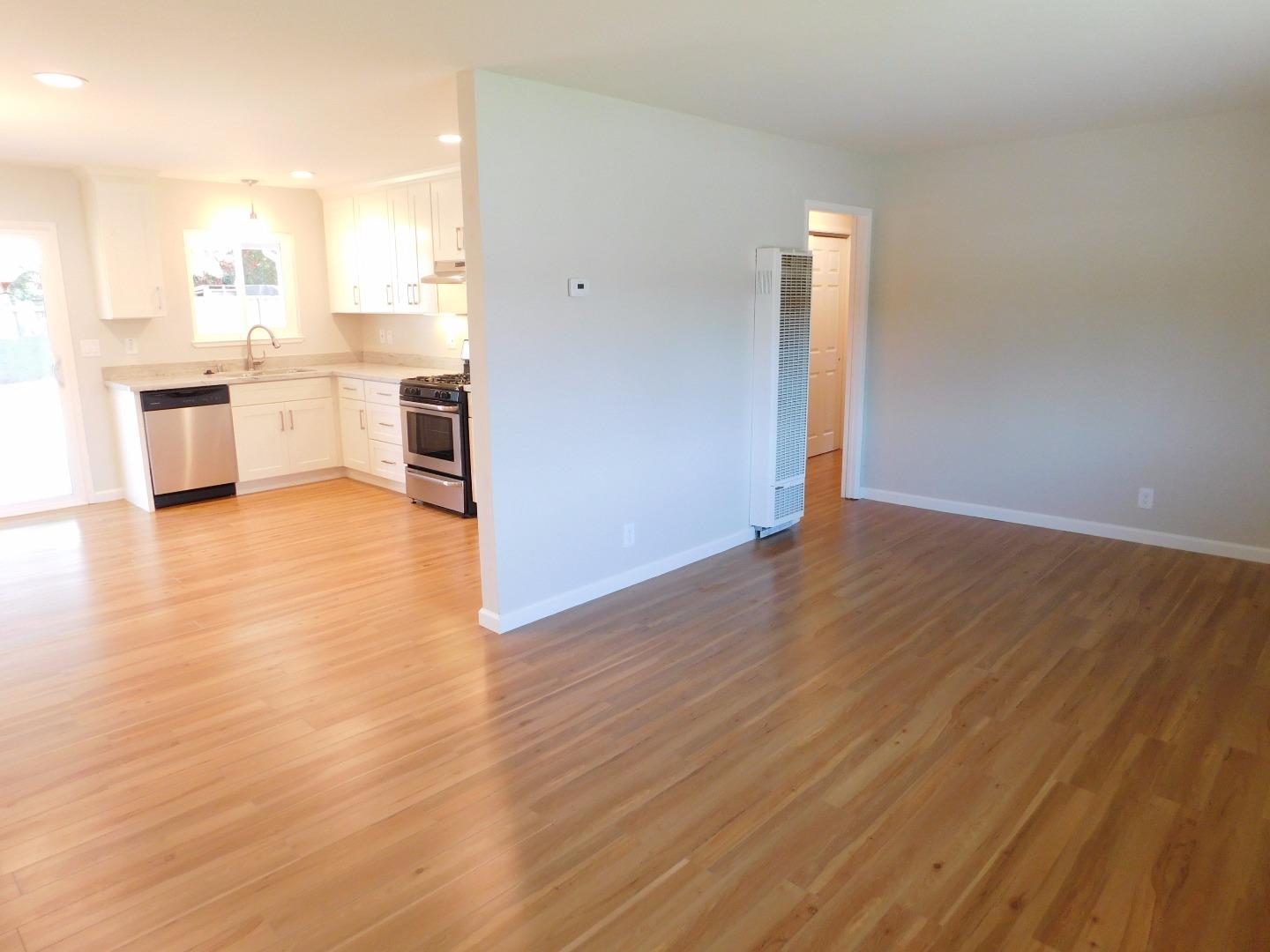 158 Dutchman Road Watsonville, CA 95076 - Photo 3 of 15 an empty room with wooden floor and windows