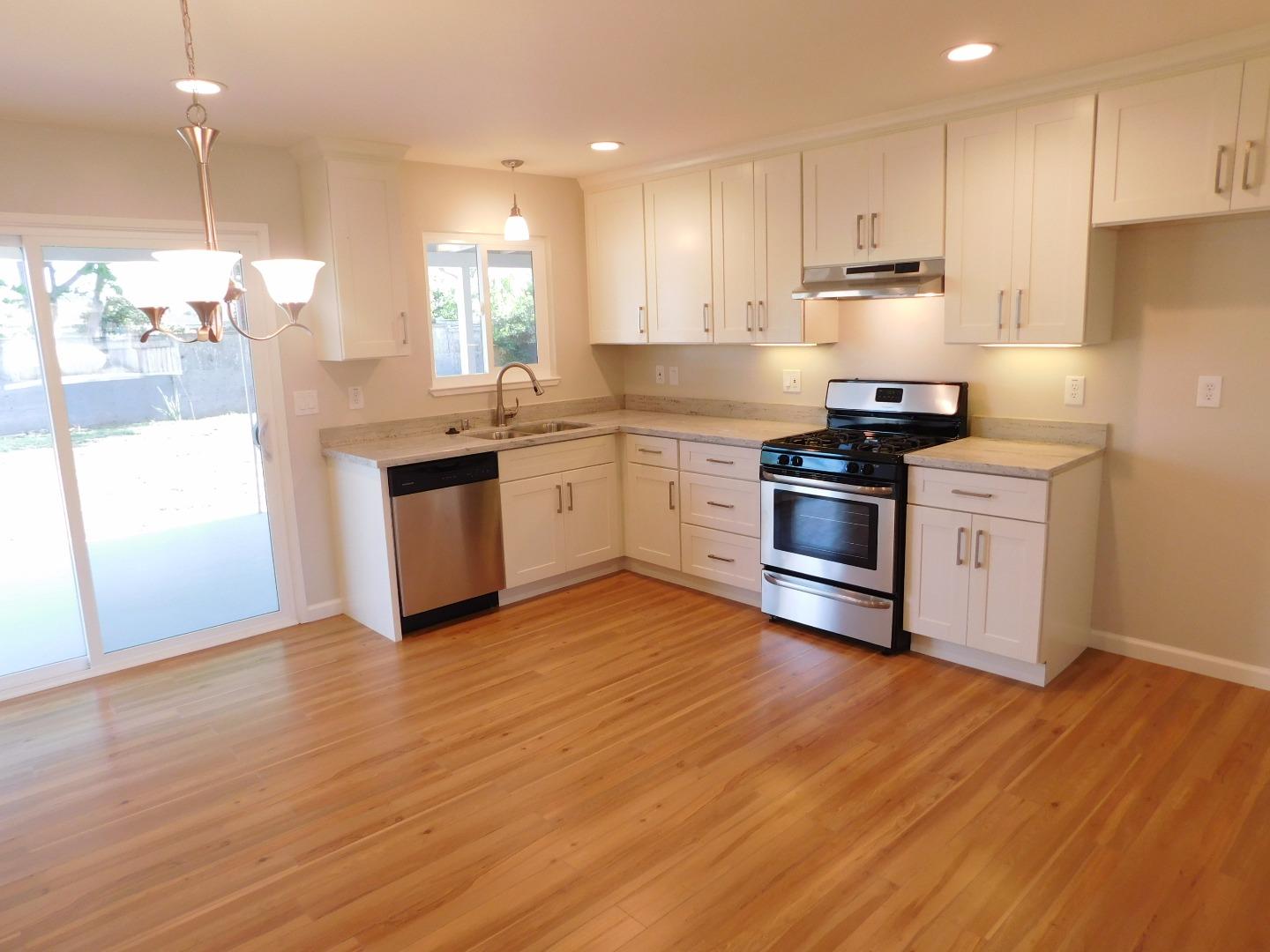 158 Dutchman Road Watsonville, CA 95076 - Photo 4 of 15 a kitchen with stainless steel appliances granite countertop a stove a sink and a refrigerator