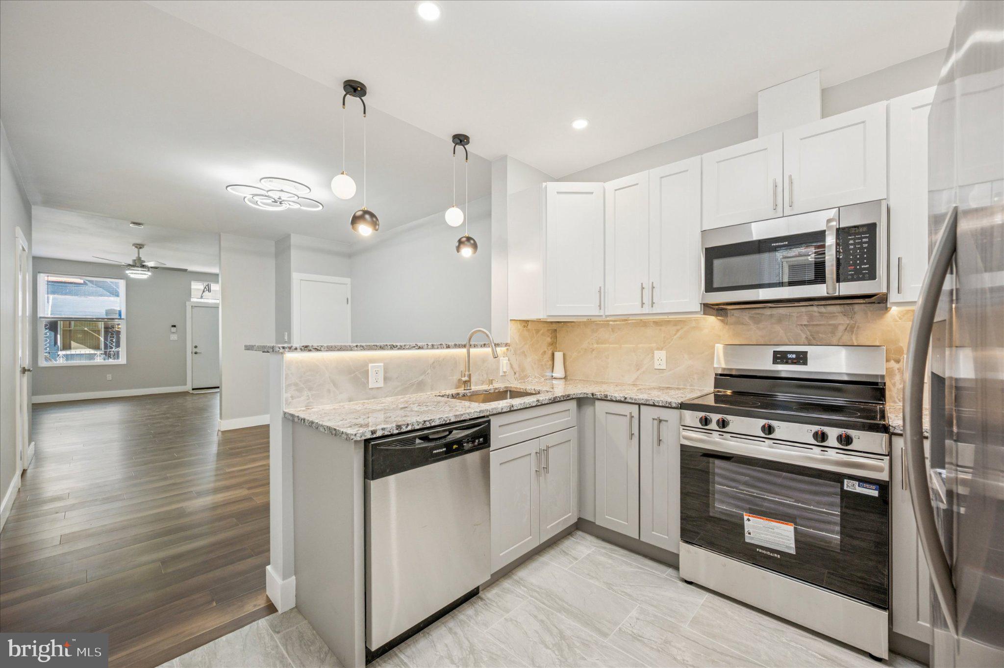 3026 Page Street Philadelphia, PA 19121 - Photo 1 of 24 a kitchen with a stove and a microwave