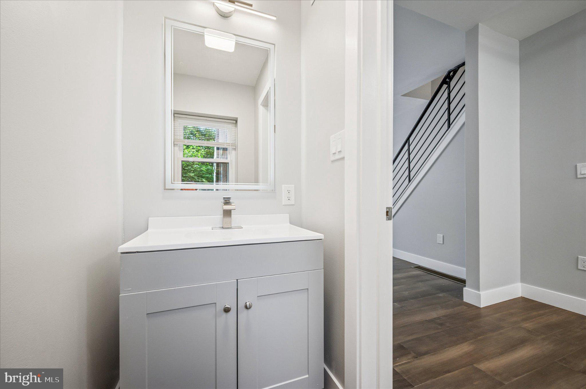 3026 Page Street Philadelphia, PA 19121 - Photo 11 of 24 a en suite bathroom with a sink and mirror