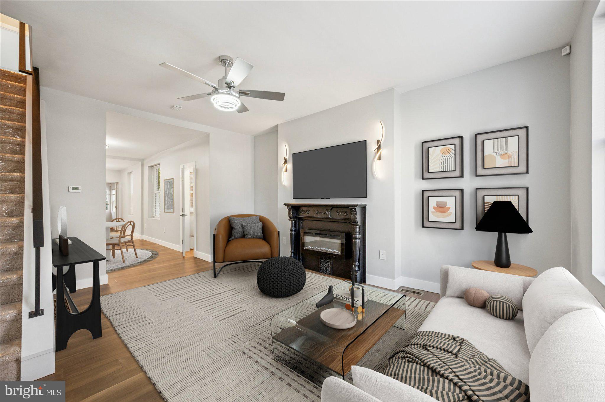3026 Page Street Philadelphia, PA 19121 - Photo 20 of 24 a living room with furniture a flat screen tv and a fireplace