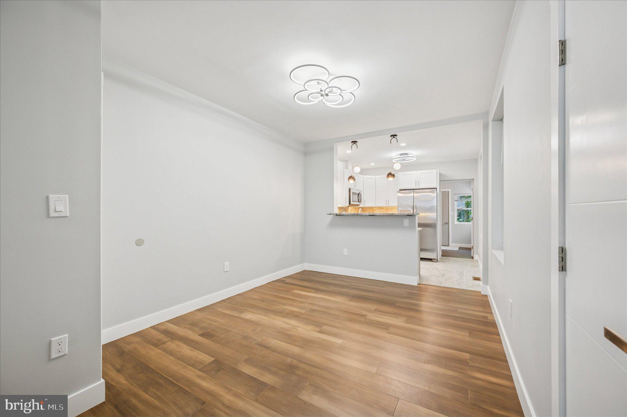3026 Page Street Philadelphia, PA 19121 - Photo 3 of 24 a bedroom with a bed and a chandelier