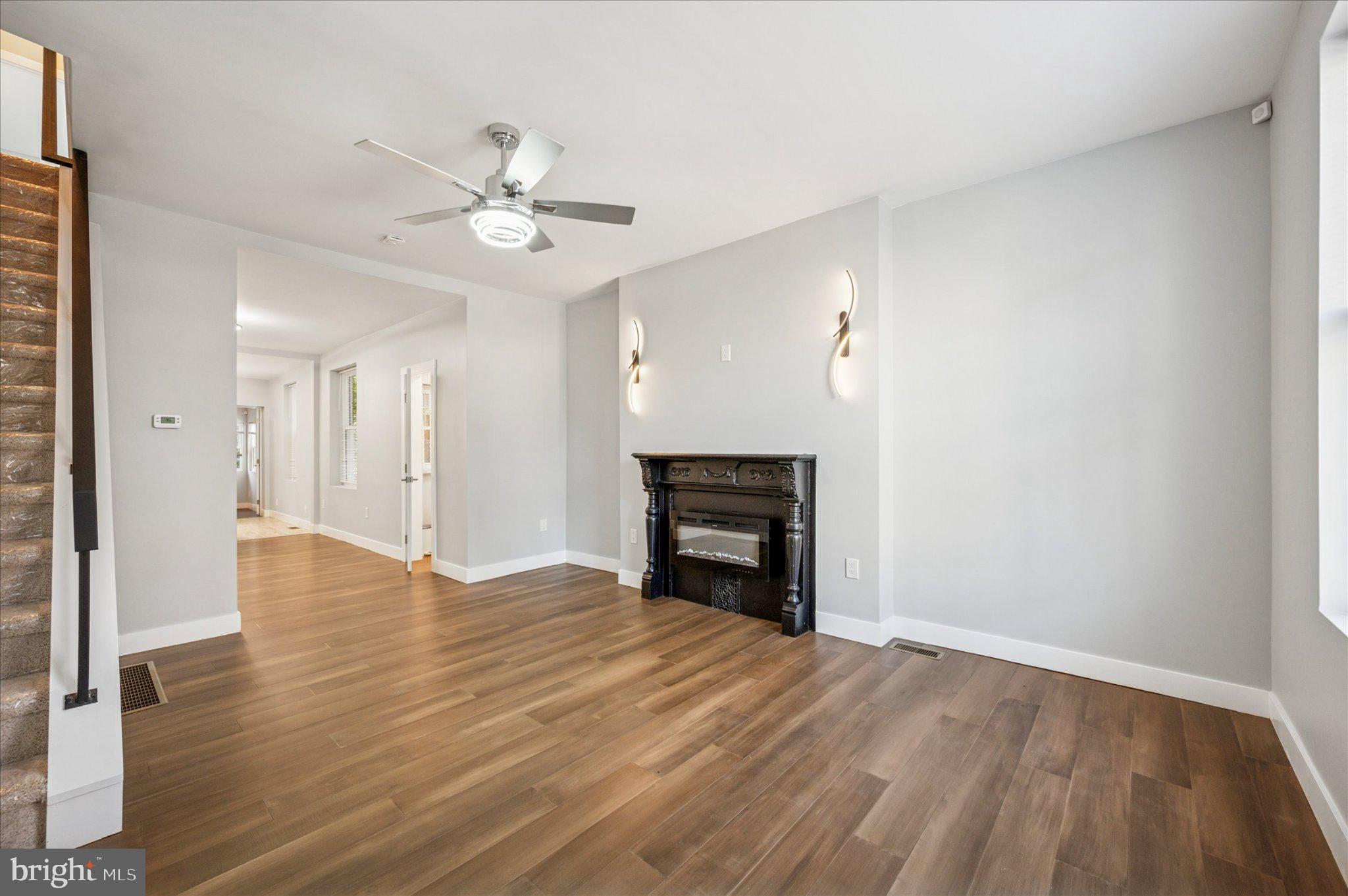 3026 Page Street Philadelphia, PA 19121 - Photo 5 of 24 a view of empty room with wooden floor and ceiling fan