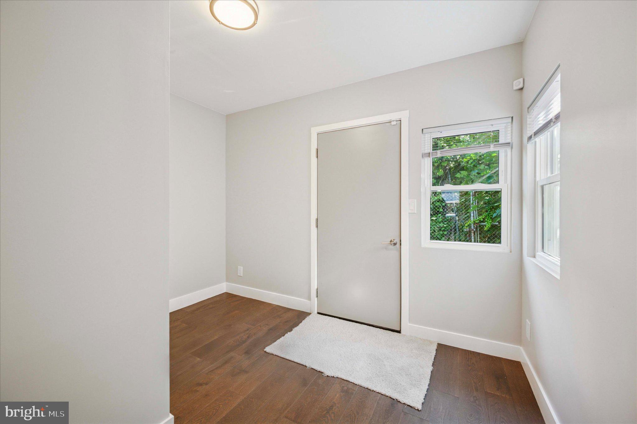 3026 Page Street Philadelphia, PA 19121 - Photo 10 of 24 a view of an empty room with wooden floor and windows