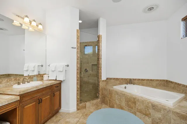 a bathroom with a granite countertop sink mirror toilet and bathtub