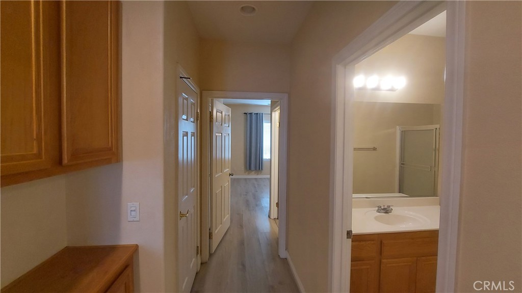 16124 Holly Ridge Court Victorville, CA 92395 - Photo 11 of 24 a bathroom with a sink and mirror