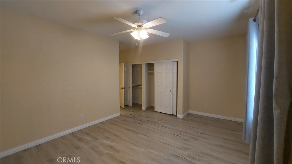 16124 Holly Ridge Court Victorville, CA 92395 - Photo 13 of 24 a view of an empty room with wooden floor