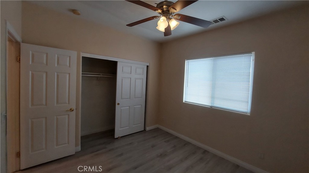 16124 Holly Ridge Court Victorville, CA 92395 - Photo 15 of 24 an empty room with closet and a chandelier fan