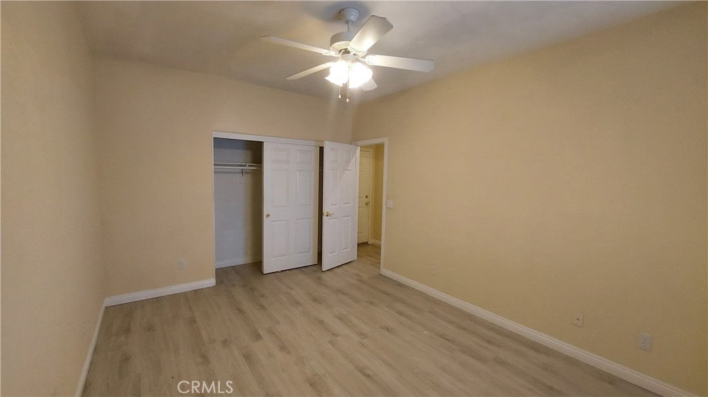 16124 Holly Ridge Court Victorville, CA 92395 - Photo 16 of 24 a view of an empty room with wooden floor