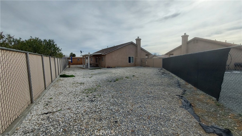 16124 Holly Ridge Court Victorville, CA 92395 - Photo 19 of 24 a view of a house with a backyard