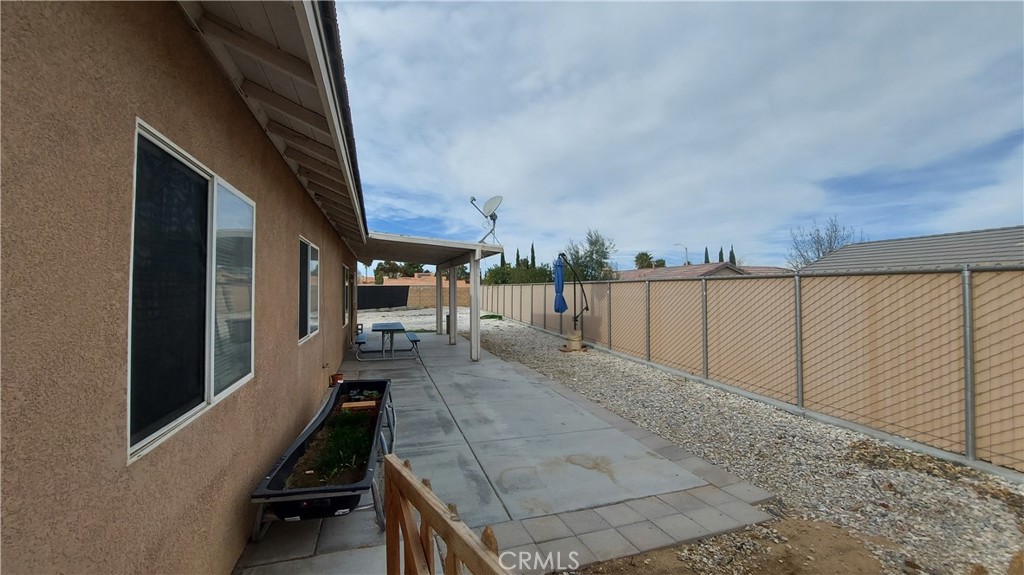 16124 Holly Ridge Court Victorville, CA 92395 - Photo 22 of 24 a view of a balcony with chairs and wooden fence