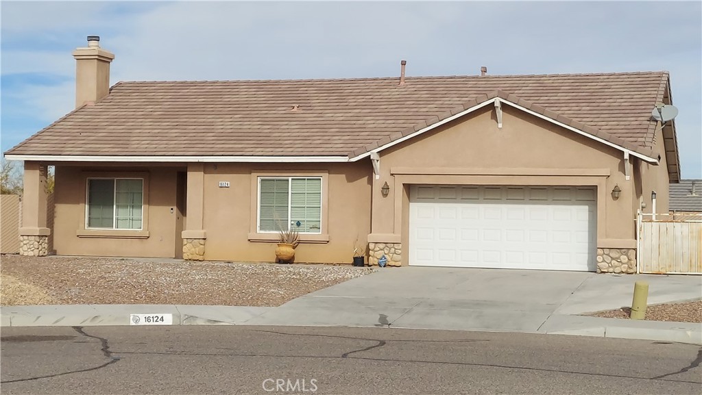 16124 Holly Ridge Court Victorville, CA 92395 - Photo 3 of 24 a front view of a house with a garage