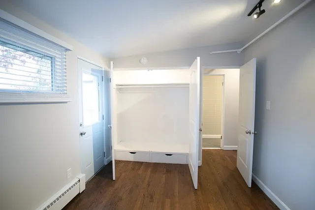 a view of a room with wooden floor