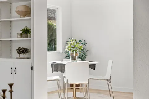 a view of empty room with wooden floor and windows
