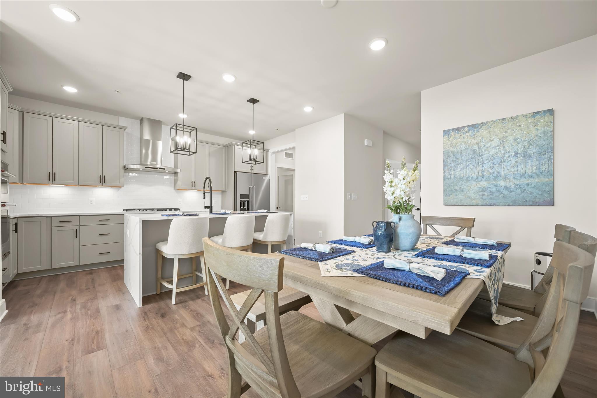 8104 Lisa Lane Fulton, MD 20759 - Photo 11 of 54 a kitchen with a dining table chairs and white cabinets