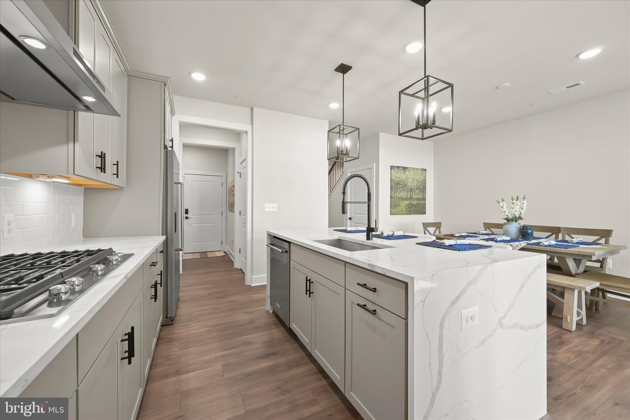 8104 Lisa Lane Fulton, MD 20759 - Photo 14 of 54 a kitchen with stainless steel appliances a stove oven a sink dishwasher and white cabinets with wooden floor