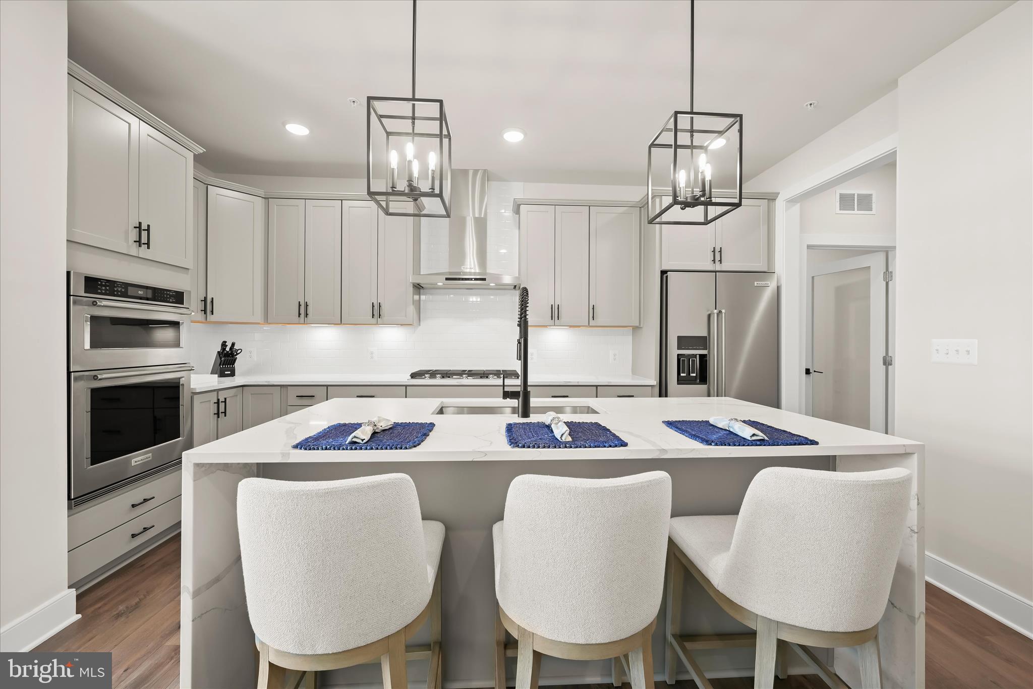 8104 Lisa Lane Fulton, MD 20759 - Photo 15 of 54 a kitchen with stainless steel appliances granite countertop a dining table chairs refrigerator and sink
